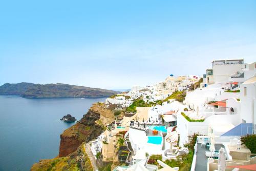 a view from a balcony of a small town at Kaleidoscope Cave Houses in Oia