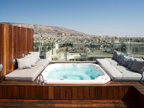 a jacuzzi tub sitting on top of a building at Periscope in Athens