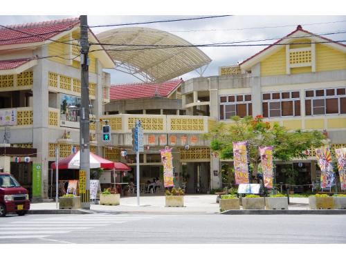 a city street with a large building with a street at Adan hotel in Nago