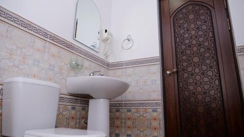a bathroom with a toilet and a sink at AYUB Boutique Hotel in Bukhara