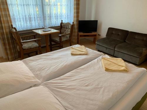 a bedroom with a large bed and a couch at Hotel Jeong in Moers