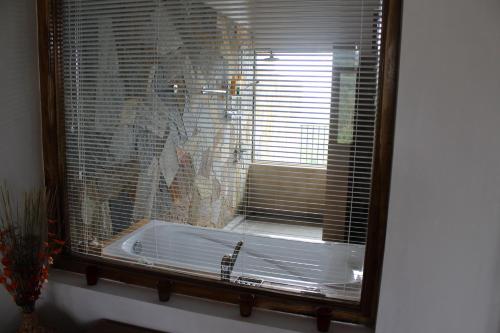 a window with a bath tub in a bathroom at Jim's Farm Villas in Madawala