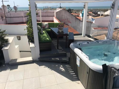 a hot tub on a balcony with a table at The Birds Nest in Alvor
