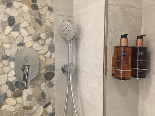 a shower with a blow dryer in a bathroom at The Birds Nest in Alvor
