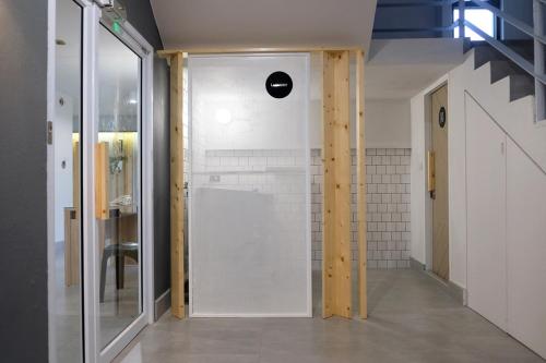 a bathroom with a shower with a glass door at Siam Mansion - SHA in Hat Yai
