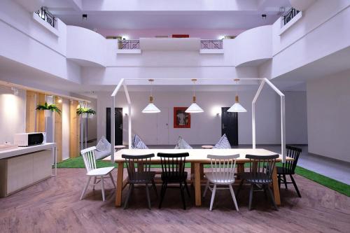 a dining room with a table and chairs at Siam Mansion - SHA in Hat Yai