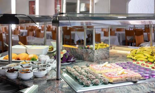 a buffet of food on a table with fruits and vegetables at Hotel Palia Don Pedro in Costa Del Silencio