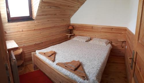 a bedroom with a bed in a wooden room at Woden apartment in Žabljak
