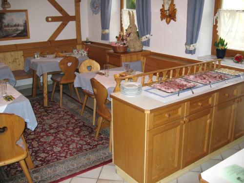 a dining room with a table and tables and chairs at Gerstbreinhof in Bad Sankt Leonhard im Lavanttal
