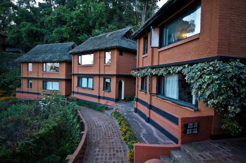 a building with a brick walkway in front of it at Dhulikhel Mountain Resort in Dhulikhel