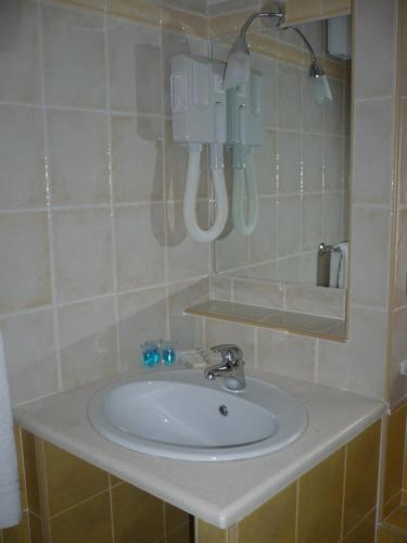 a bathroom with a white sink and a mirror at Hotel Ristorante Antica Marina in Nicotera Marina