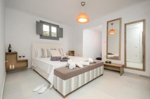 a bedroom with a large bed and a large mirror at Villa Tranquillity in Kastraki Naxou