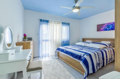 a bedroom with a bed and a desk and a sink at House Riva in Zavalatica