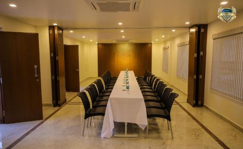 a conference room with a table and chairs at Kensington Suites in Bengaluru