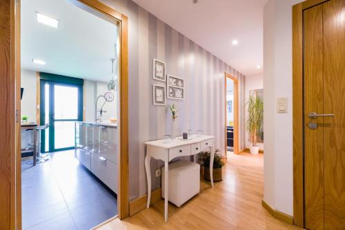 a bathroom with a white sink and a mirror at Bocanoite Stellae in Arzúa