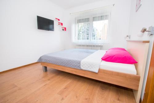 a bedroom with a bed and a television in it at NADA in Karlovac
