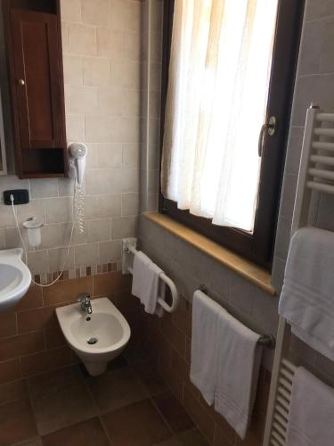 a bathroom with a sink and a toilet and a window at Il Podere del Carlone in Vasto