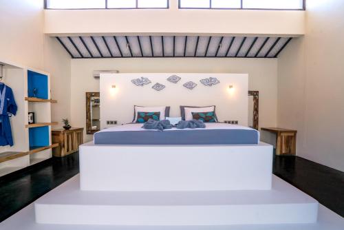 a bedroom with a large bed in a room at Stay Shark Villas Gili Air in Gili Islands