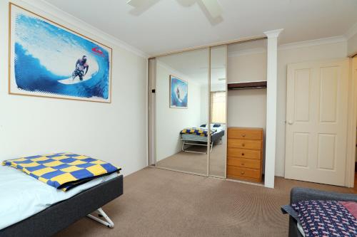 a bedroom with a bed and a mirror at 230 Alice Street in Perth