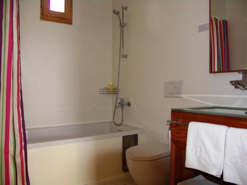 
a bathroom with a toilet, tub, sink and shower at Hotel Gracanica in Prishtinë
