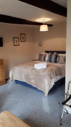 a bedroom with a large bed in a room at The Clifden Arms B&B in Worminghall