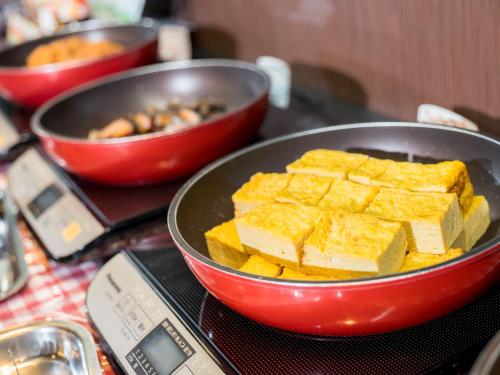 a pan filled with food on top of a table at Super Hotel Aomori in Aomori