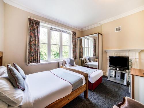 a hotel room with two beds and a television at The Briary in Sheffield