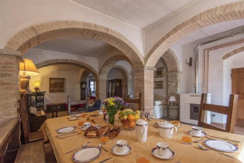 a dining room with a table with food on it at Podere Badia Valdrago Agriturismo Mugello Circuit in Scarperia