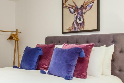 a bed with pillows and a picture of a deer at ONE MOORGATE VIEW in York