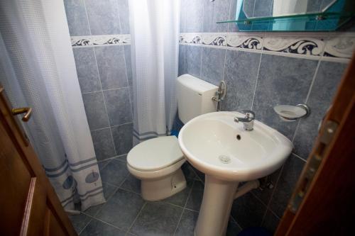 a small bathroom with a toilet and a sink at Studios Nikezić in Utjeha