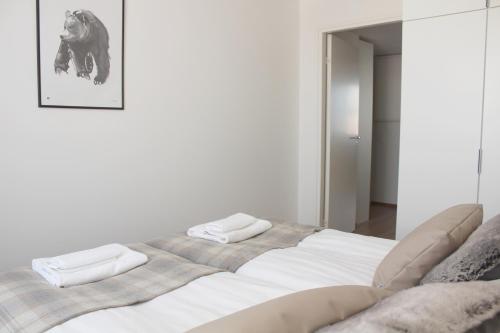 a large white bed with two pillows on it at Forenom Serviced Apartments Rovaniemi Valtakatu in Rovaniemi