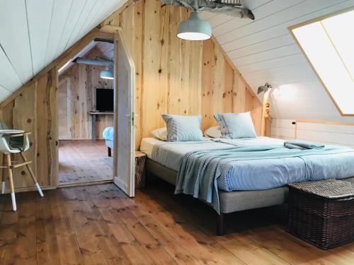 a bedroom with a large bed in a attic at Jaagu-Mihkli Muhu Island in Ridasi
