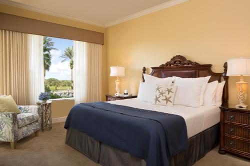a bedroom with a large bed and a window at Hammock Beach Golf Resort & Spa in Palm Coast
