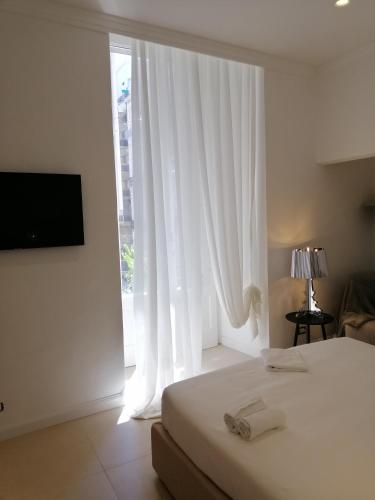 a bedroom with a bed and a large window at BARI 102 in Bari
