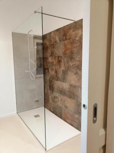 a shower with a glass door in a bathroom at BARI 102 in Bari