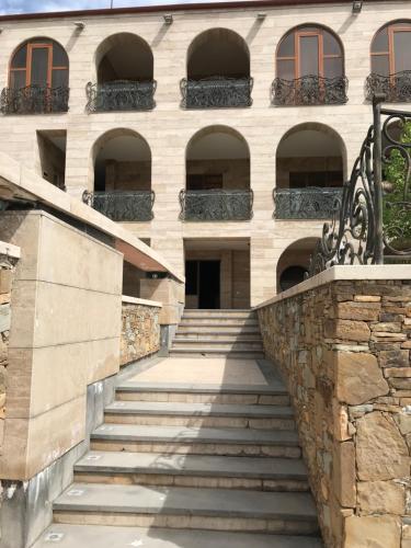 a staircase leading up to a building with windows at A Royal Luxury Villa In Center With Two Swimming Pools, Sauna and Jacuzzi. in Yerevan