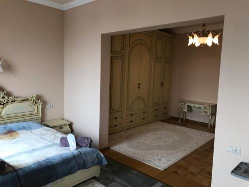 a bedroom with a bed and a large door at A Royal Luxury Villa In Center With Two Swimming Pools, Sauna and Jacuzzi. in Yerevan