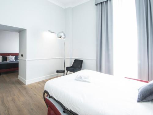 a hotel room with a bed and a chair at Gemini Suites Navona in Rome