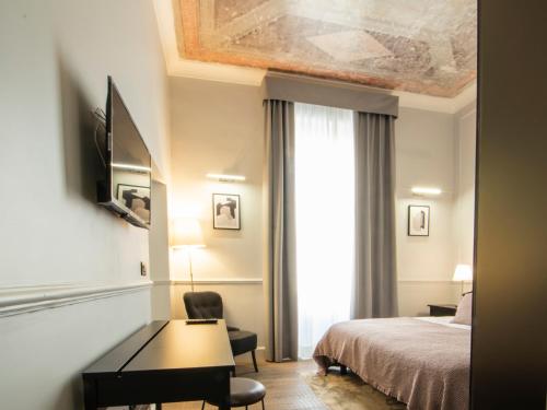 A bed or beds in a room at Holidays Suites Navona