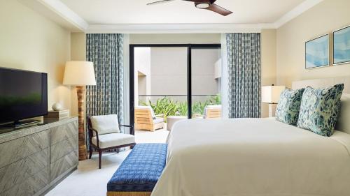 a hotel room with a bed and a television at Timbers Kauai Ocean Club & Residences in Lihue