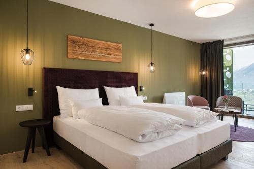 Oliven- & Genusshotel Hirzerにあるベッド