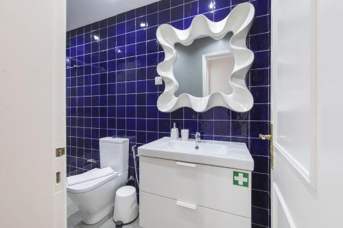 a blue tiled bathroom with a sink and a toilet at The Castle Life in 3BDR apartament in Lisbon