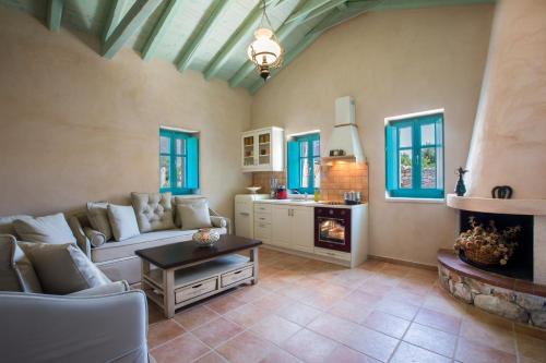 a living room with a couch and a fireplace at Pandora in Pirgos Dhirou