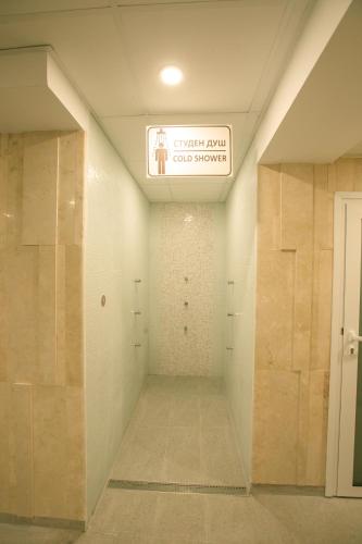 a hallway in a building with a sign on the ceiling at Perun Hotel Sandanski in Sandanski