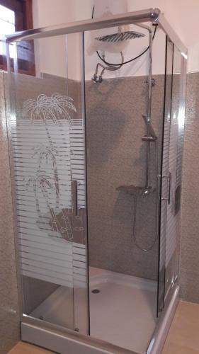 a shower with a glass enclosure in a bathroom at Risenlak Holiday Resort in Polonnaruwa