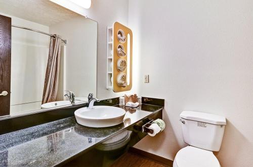 a white bathroom with a sink and a toilet at Economy Inn Pittsburgh Airport in Moon