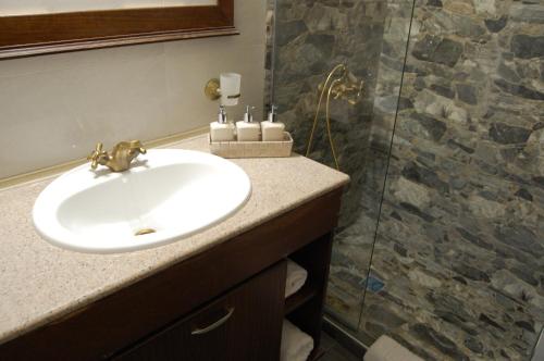 a bathroom with a sink and a shower at Paralia Beach Boutique Hotel in Paralia Katerinis