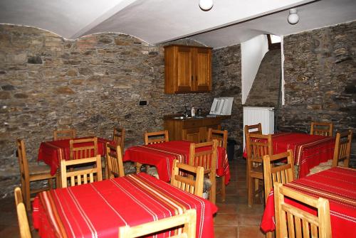 a restaurant with red tables and wooden chairs at Apartmany A.Ša Kašperské Hory in Kašperské Hory