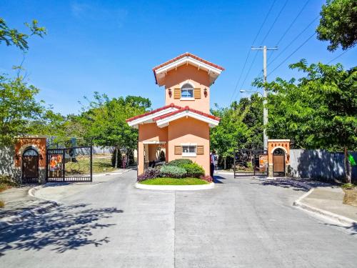 a small pink building in the middle of a street at Hillview Apt w/ Pool Access - Free Wifi in Tagbilaran City