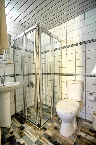a bathroom with a toilet and a sink at Mera Park Hotel in Antalya